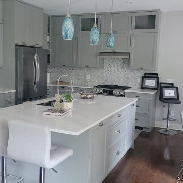 Grey cabinet kitchen with blue pendant lights